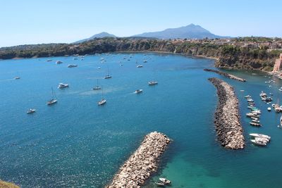 High angle view of sailboats in sea against clear sky