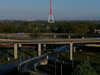 Train on bridge in city against sky