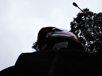 Low angle portrait of silhouette man against sky