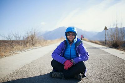 Portrait of woman standing on road