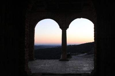 Silhouette of historical building against sky during sunset