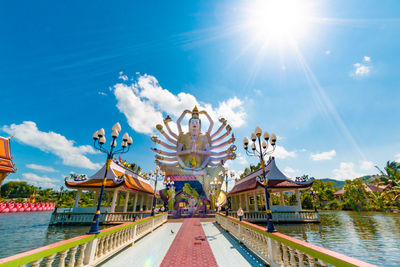 View of amusement park against cloudy sky