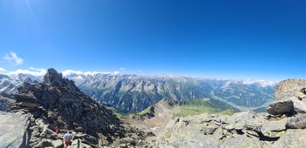 Panoramic view of snowcapped mountains against blue sky