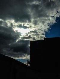 Low angle view of building against cloudy sky