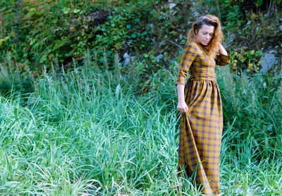 Portrait of young woman in field