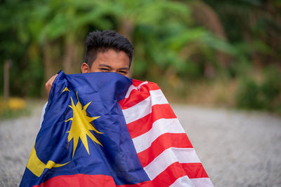 Low angle view of man standing against blue sky