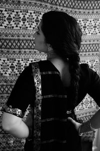 Rear view of woman standing at home