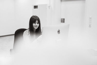 Young woman sitting at home