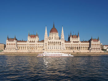 View of buildings in city against clear sky