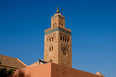 Low angle view of clock tower against blue sky
