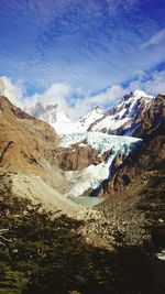 View of snowcapped mountain against cloudy sky