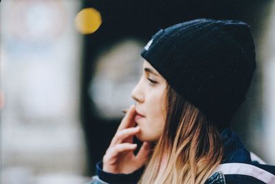 Close-up of young woman smoking cigarette