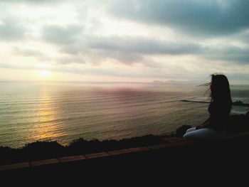 Scenic view of sea against cloudy sky