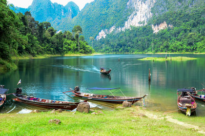Panoramic view of boats in lake against trees