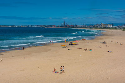 People on beach against sky