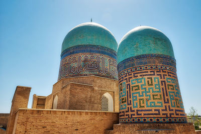 Low angle view of ornate building against clear blue sky