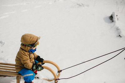 Rear view of boy in snow