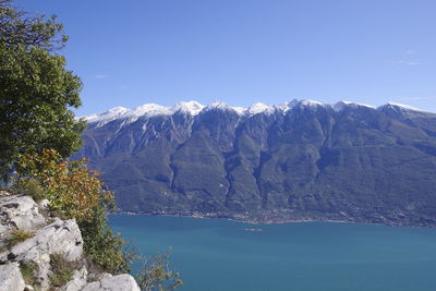 Scenic view of mountains against blue sky