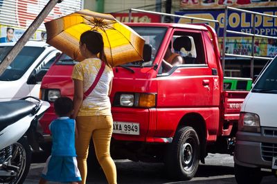 Rear view of people standing on bus