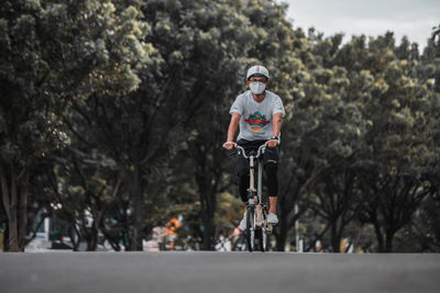 Portrait of smiling man riding bicycle on tree