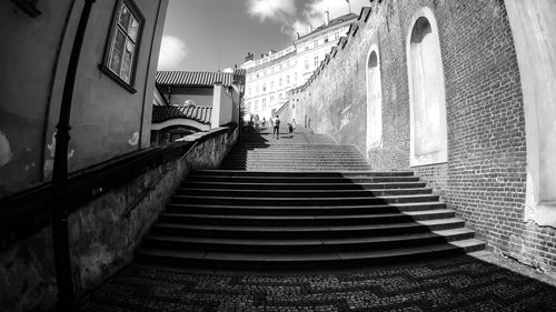 Low angle view of staircase amidst buildings in city