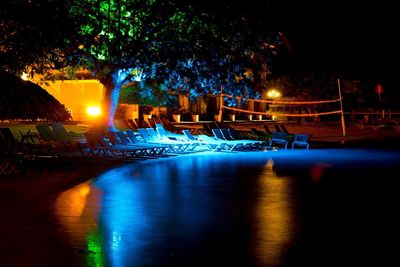 Reflection of illuminated lights in puddle