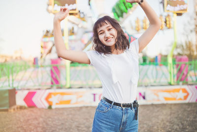 Happy beautiful asian girl in an amusement park, smiling. summer holidays and vacation 