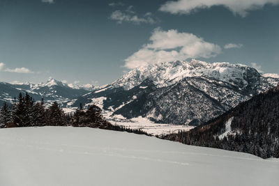 Scenic view of snowcapped mountains against sky