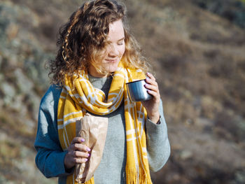 Young woman drinking outdoors