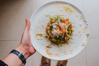 High angle view of person holding food