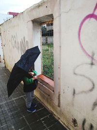 Woman with graffiti on wall
