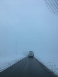 Car on road against sky during winter