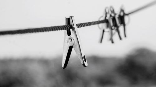 Close-up of clothespins hanging on clothesline