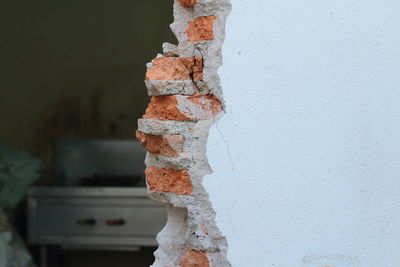 Close-up of stack on wood against wall