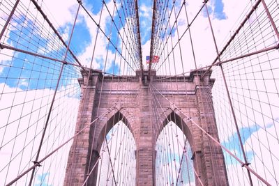 Low angle view of suspension bridge against sky