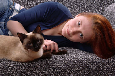 Woman with cat looking at camera