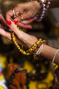 Cropped hand of woman touching jewelry