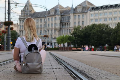 Rear view of woman sitting on tramway