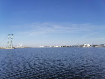 Scenic view of sea by buildings against sky