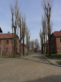 Empty road along buildings