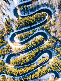 Aerial view of road amidst forest during winter