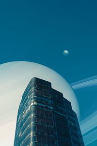 Low angle view of modern building against clear blue sky