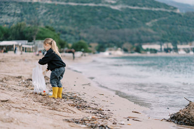 Rear view of woman walking on beach