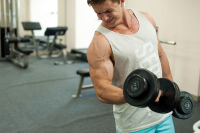 Young man exercising in gym