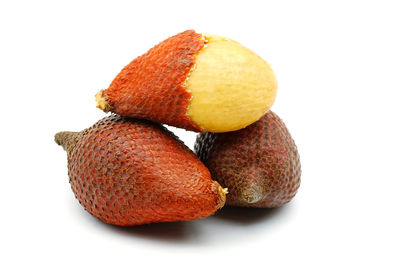 Close-up of orange fruit against white background