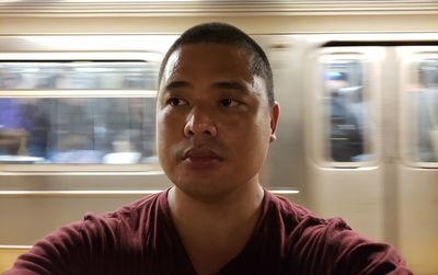 Portrait of young man in train