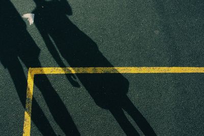 Shadow of people on road