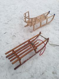 High angle view of wooden sleds on snow