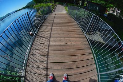 Low section of woman on footbridge