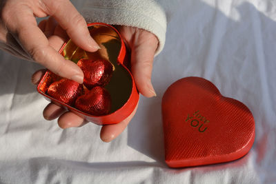 Enjoying the chocolates from the love you heart box on valentine's day